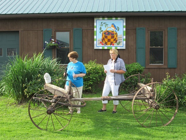 Kathy McCarty, Barn Quilt Trail co-founder, "says a few words" during the dedication while Karla Gadley looks on.